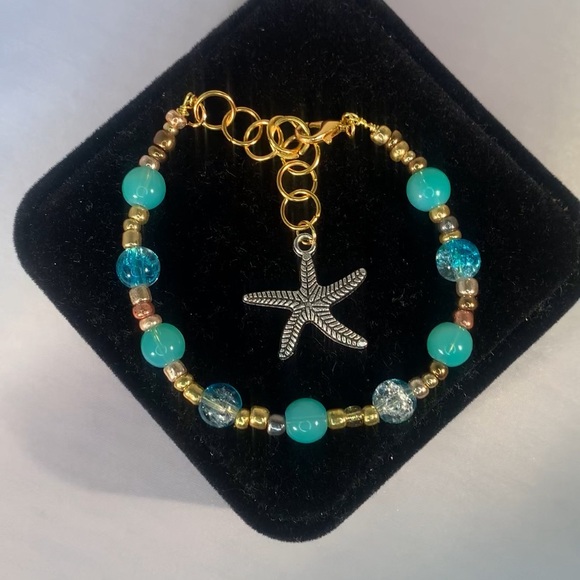 COASTAL ORBIT — Handmade Gold and Aquamarine Starfish Charm Glass Bead Bracelet - Picture 2 of 5